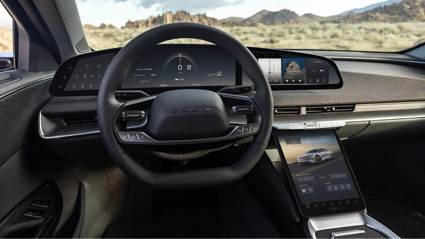 Lucid electric car interior featuring a sleek black steering wheel, digital dashboard, and large touchscreen display.
