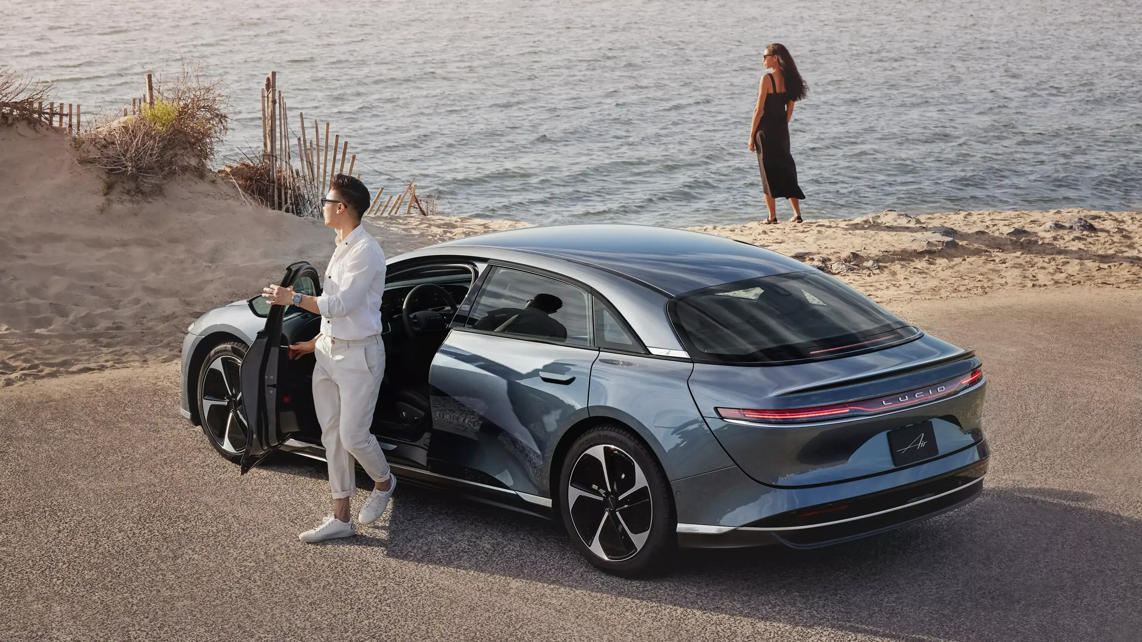 Fathom Blue Lucid Air parked by beach