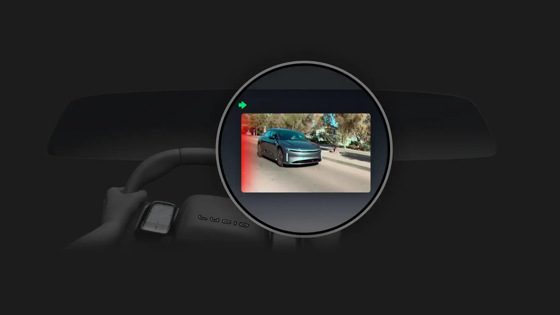 Lucid car's rearview mirror display showing a blue electric sedan on a road, with a green arrow indicator.