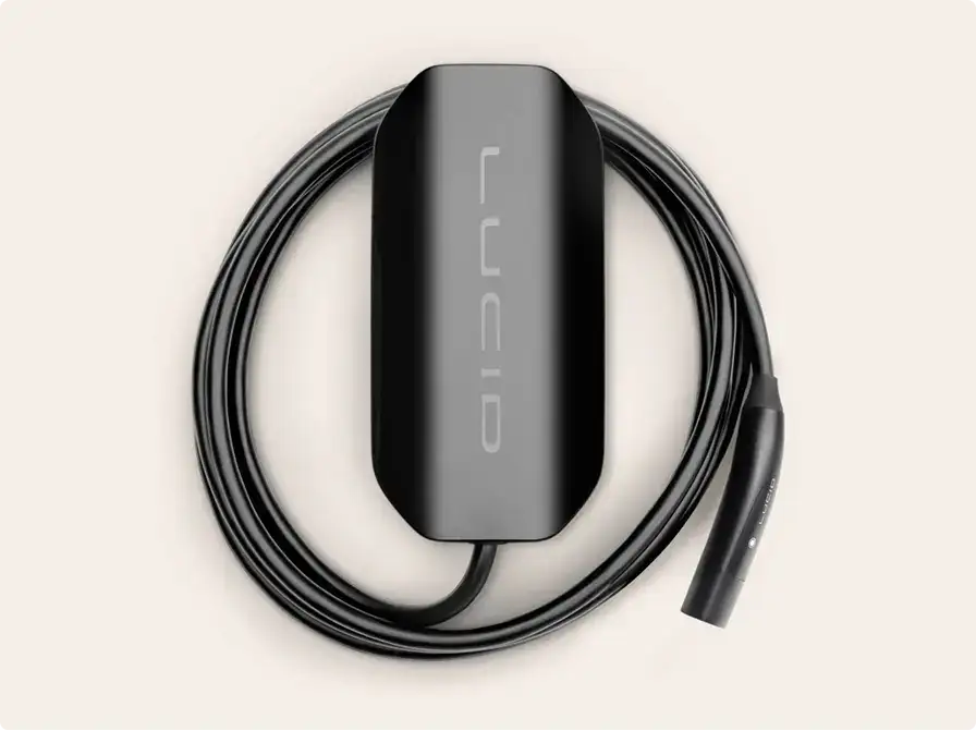 Black electronic device with "LUNO" branding and attached cable arranged in circular pattern on beige background.