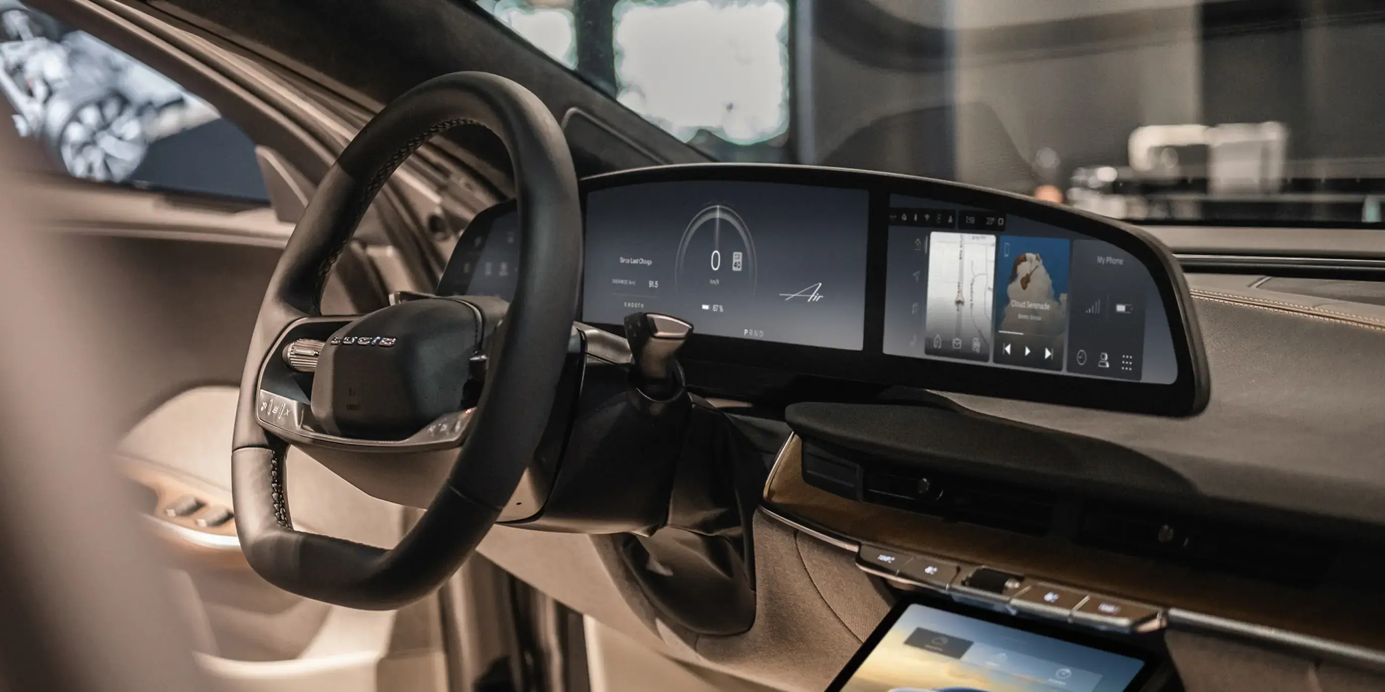 Modern luxury car interior with digital dashboard display, touchscreen console, and leather steering wheel in beige and black.