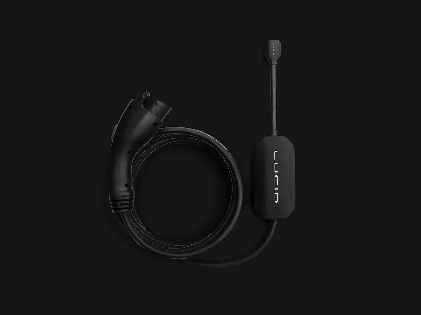 Black electric vehicle charging cable with LUCID branding on control box against dark background.