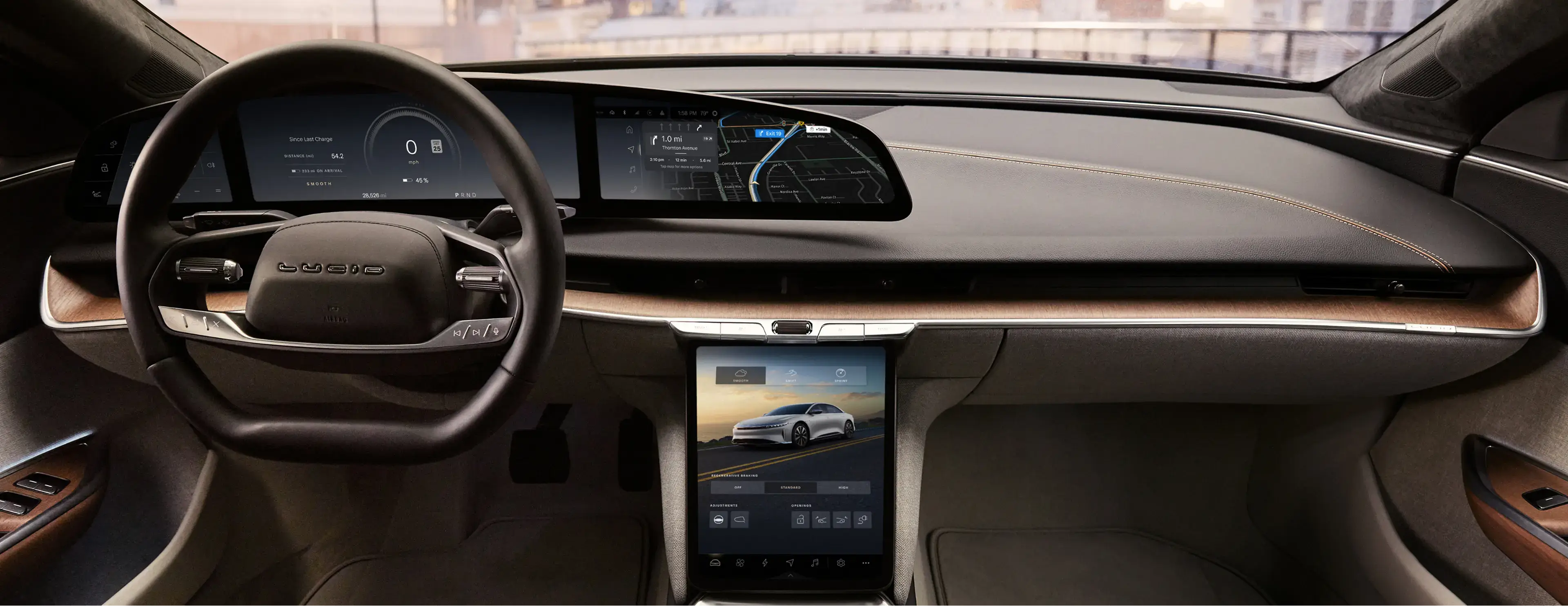 Lucid Air interior featuring a steering wheel, wide digital dashboard display, and large center touchscreen.