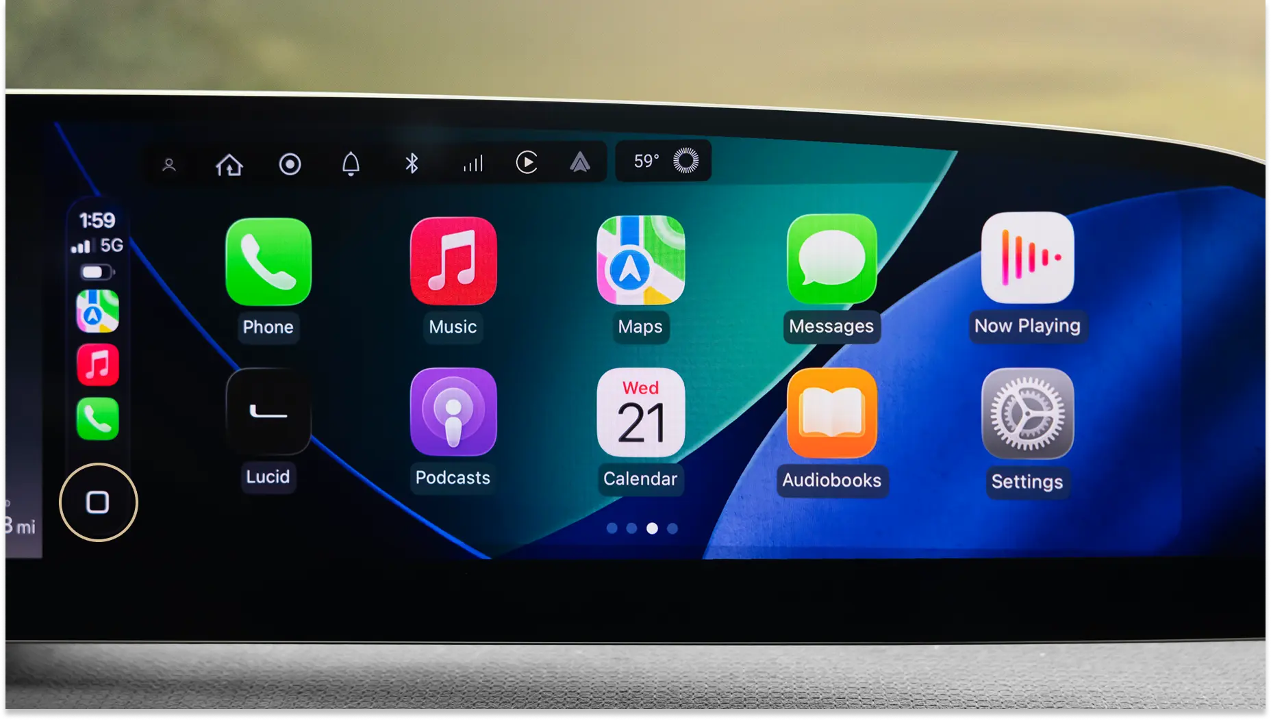 Car infotainment display showing Apple CarPlay interface with app icons including Phone, Music, Maps and Messages.