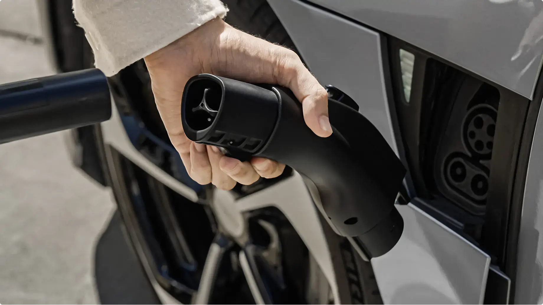 Firmly insert the NACS charging connector into the corresponding opening on the adapter until you hear a click. Check that the adapter is fully and tightly connected and make sure you are using the correct AC adapter for Level 2 charging at home or on the road.