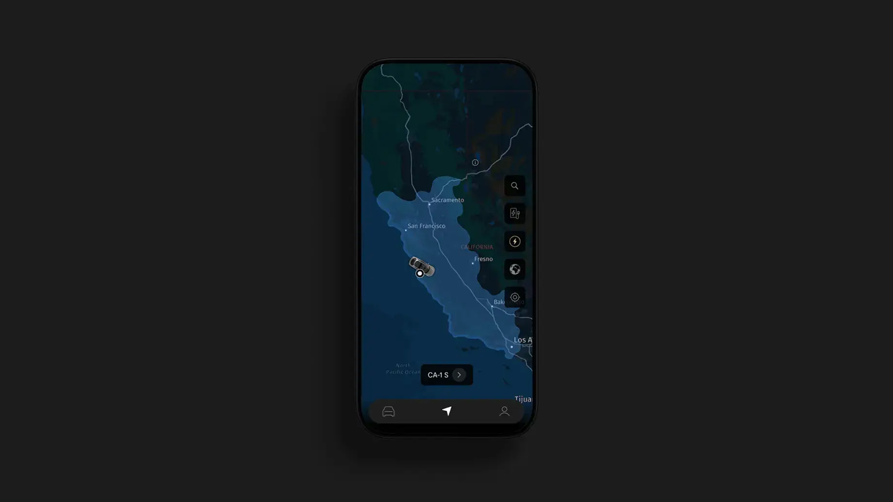 A smartphone displaying a dark-themed navigation app showing a route along California's coast with a CA-1 S direction prompt.