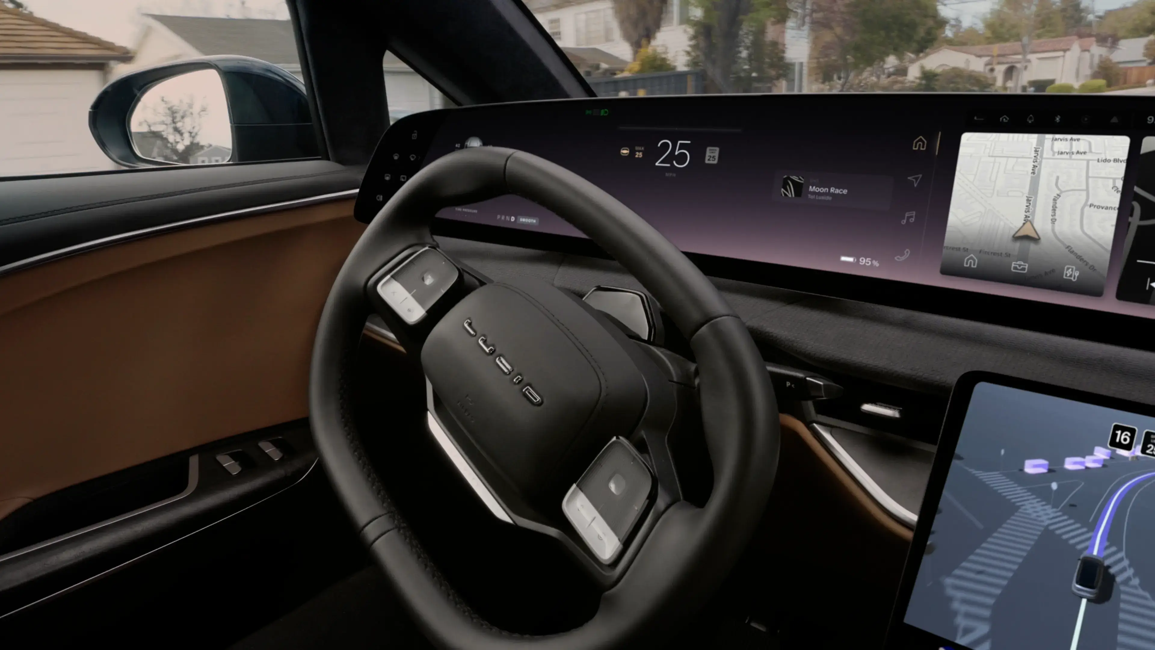 Interior view of a Lucid electric car showing a black steering wheel, wide touchscreen dashboard, and navigation map display.