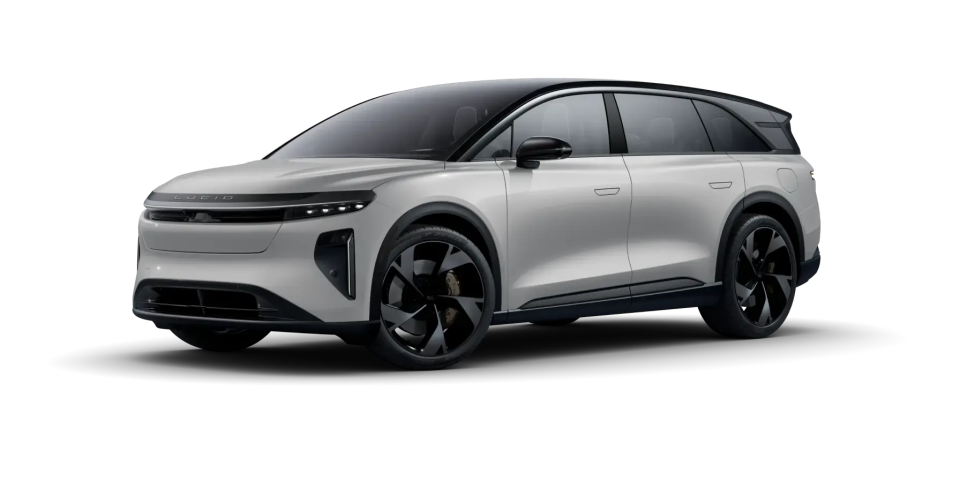 Lucid Gravity SUV with sleek design, black roof, and distinctive black turbine-style wheels against white background.