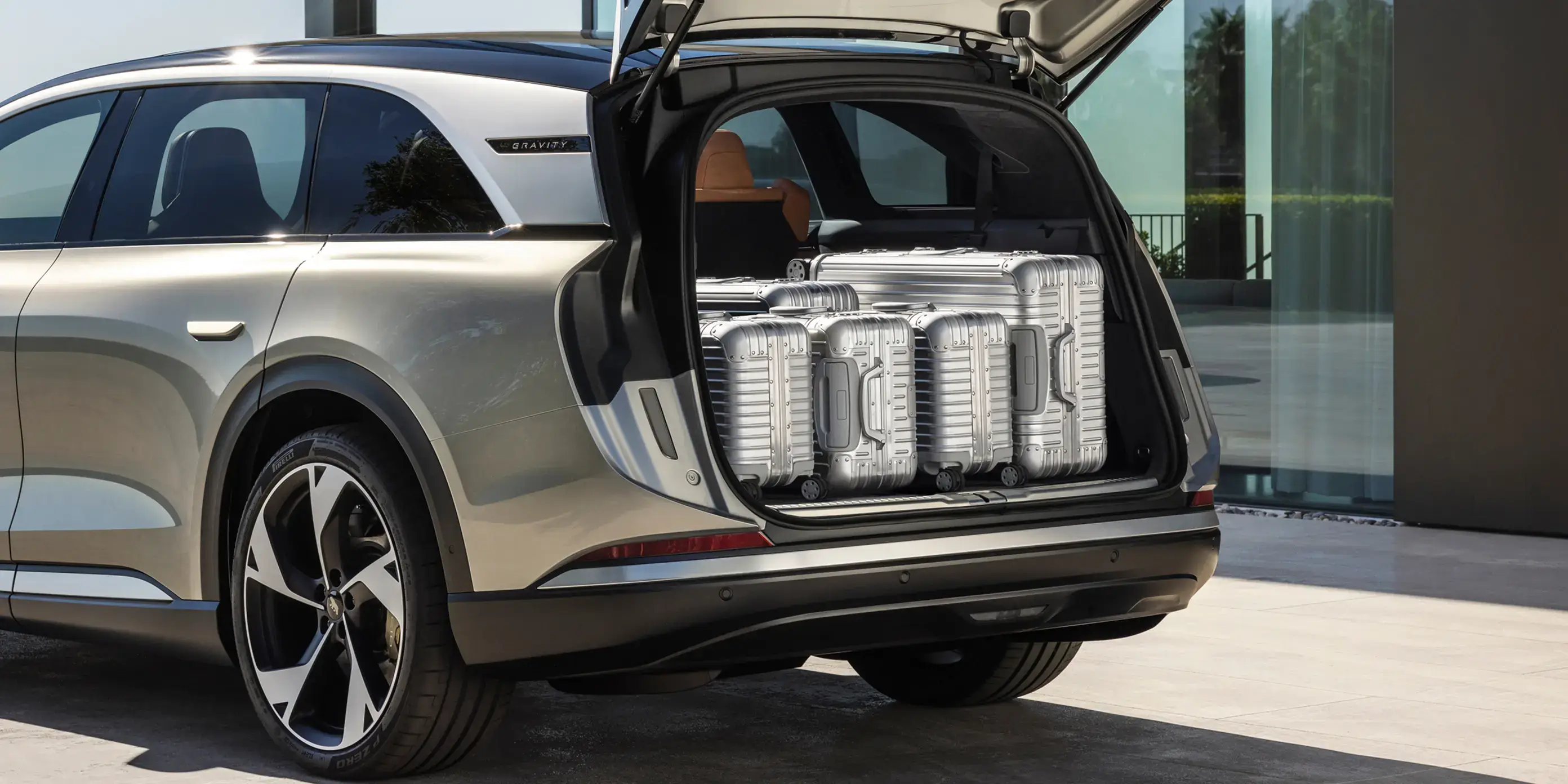 The trunk open with 5 suitcases inside.