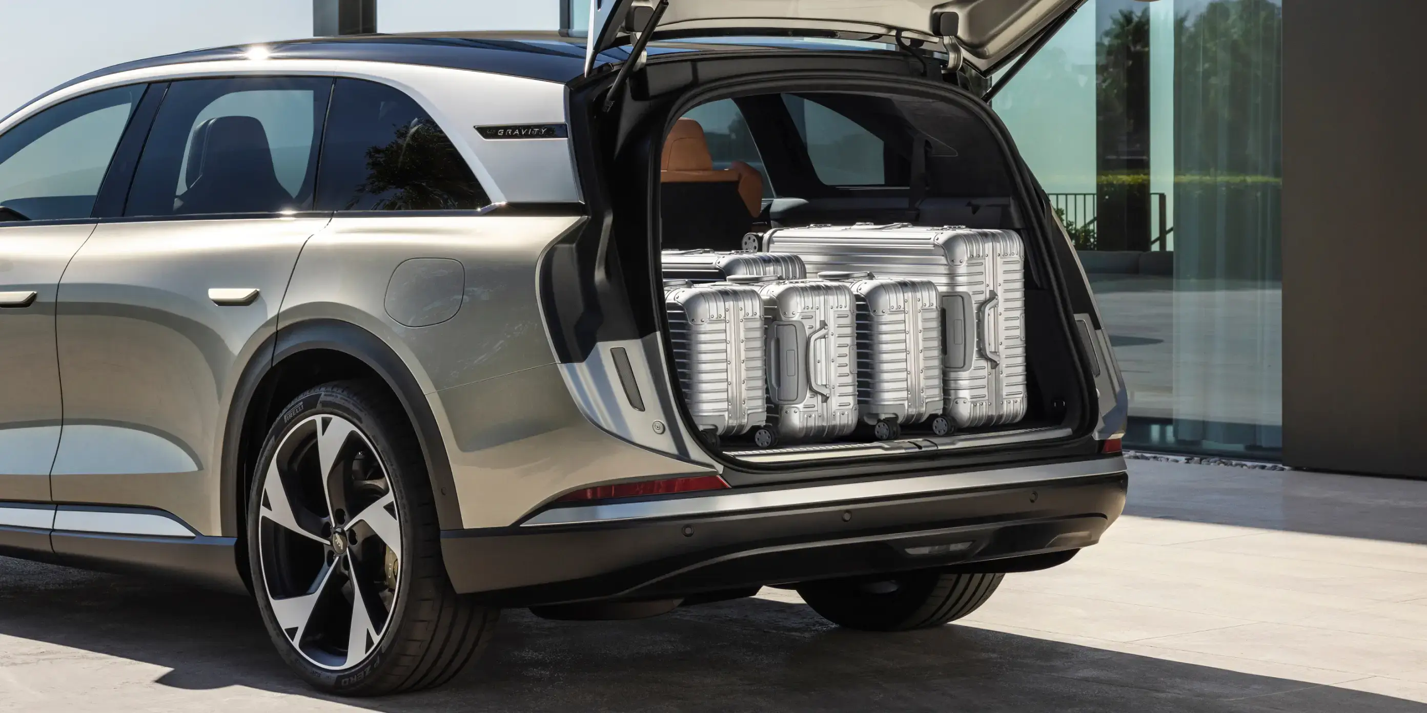 The trunk open with 5 suitcases inside.