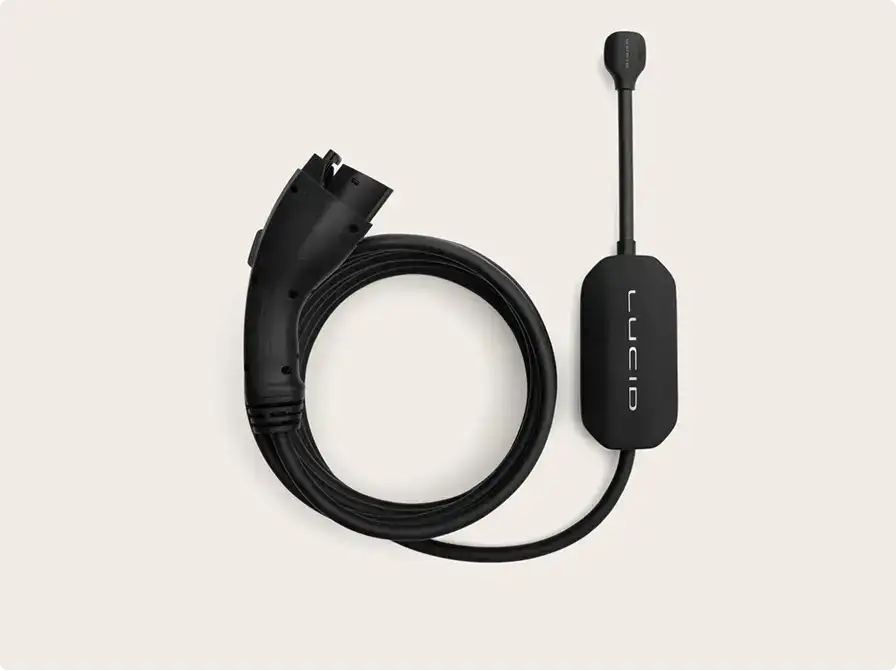 Black electric vehicle charging cable with connector and control module displaying "Lucid" branding on beige background.