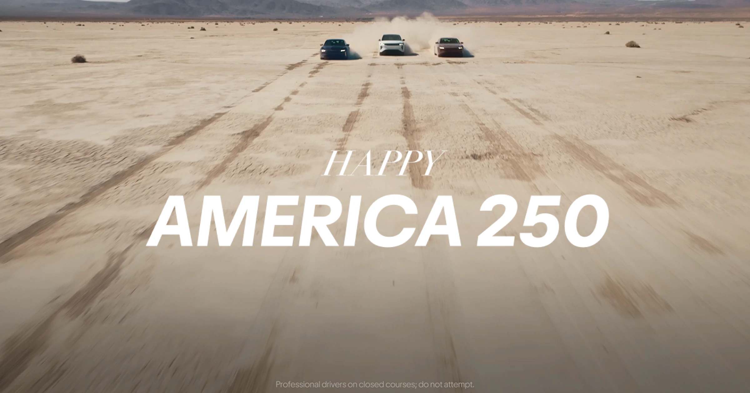 Three cars racing across a sandy desert with text overlay reading "Happy America 250."