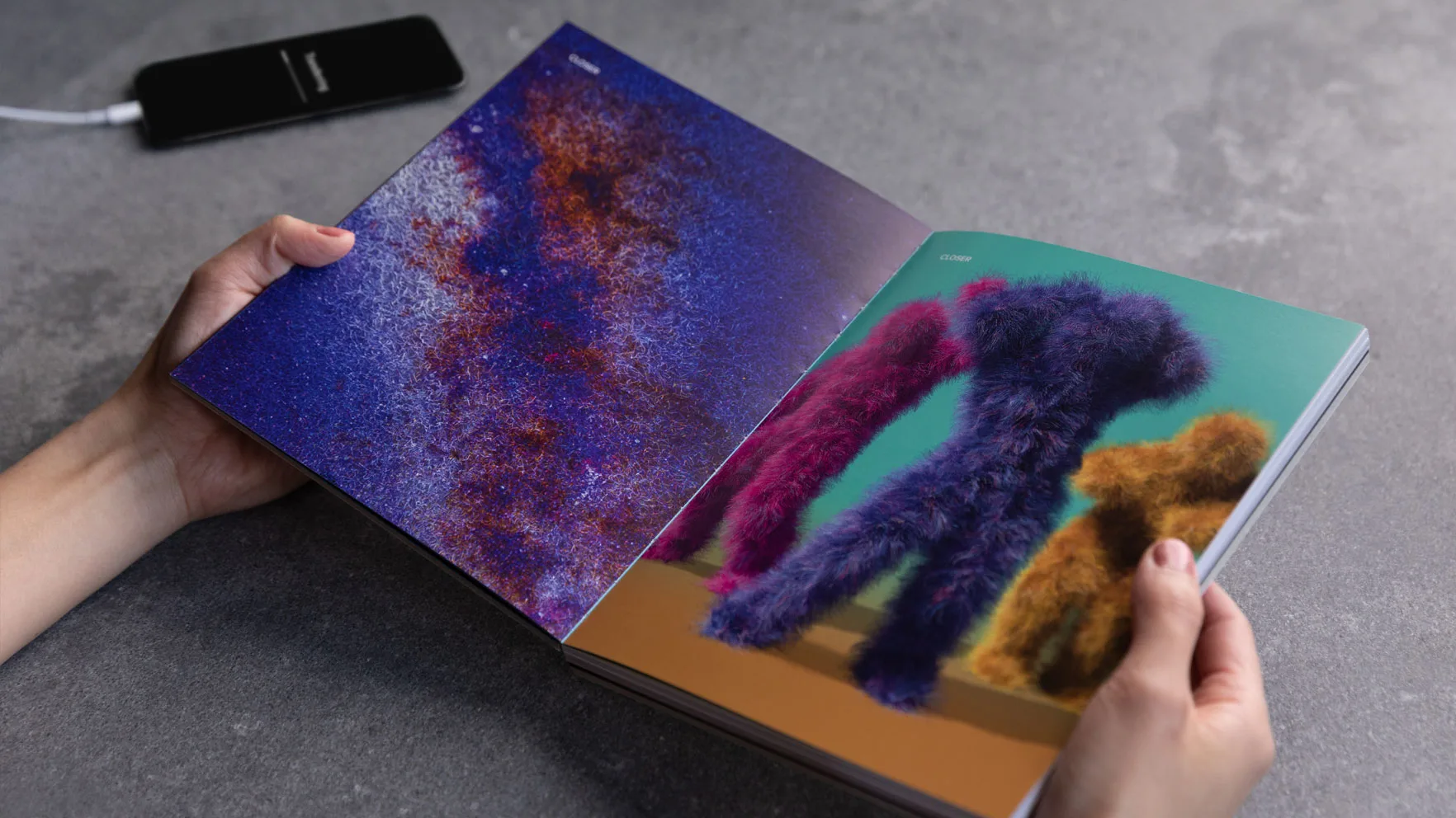 Two hands hold The Book Of Limbo. One page is a close up of the Milky Way galaxy. The other are colourful fluffy dancing figures.
