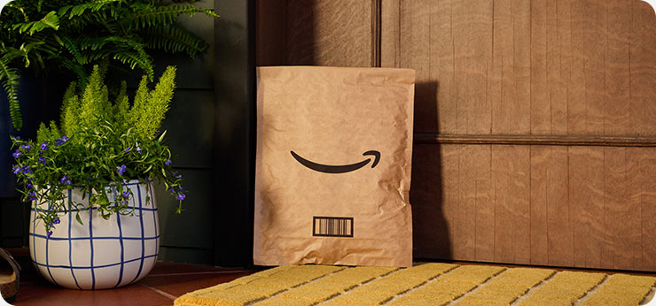A package with the Amazon smile logo sitting on a doorstep