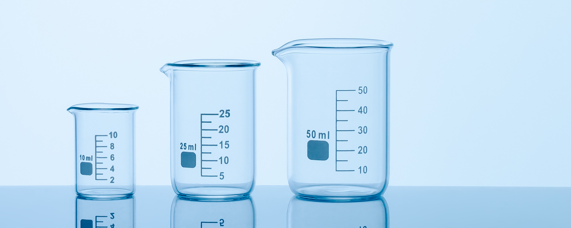 Three differently-sized beakers on a table