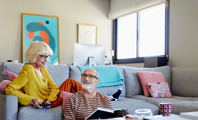 An image of two parents sitting in their living room.