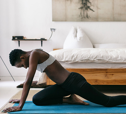 An image of a woman doing yoga in their home.