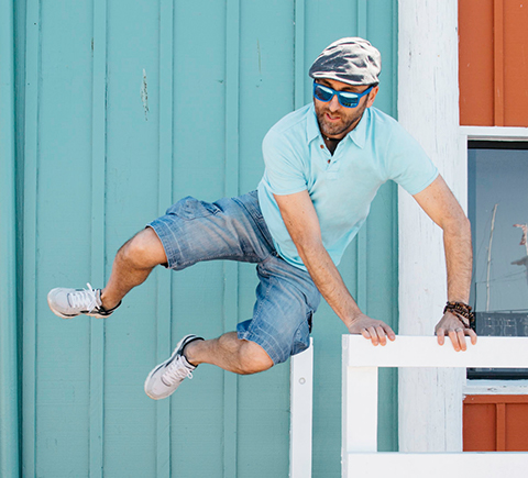 A man jumping over a guard rail