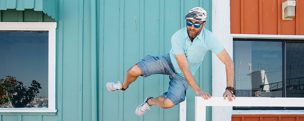 A man jumping over a guard rail