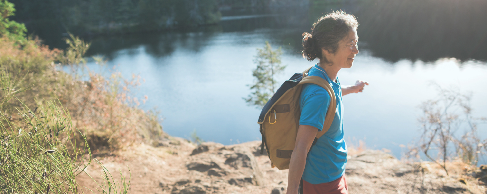 woman hiking near a lake