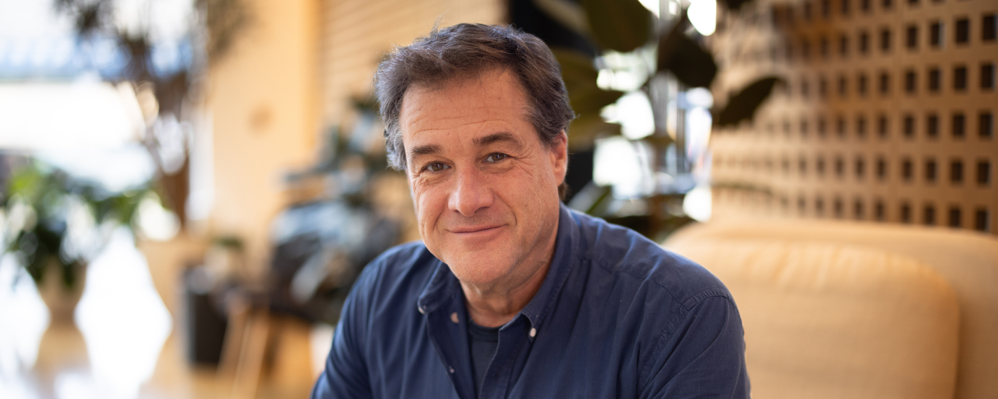 Photograph of Rob Fried smiling, facing the camera, daylight. 