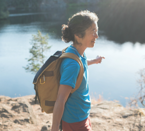 woman hiking near a lake