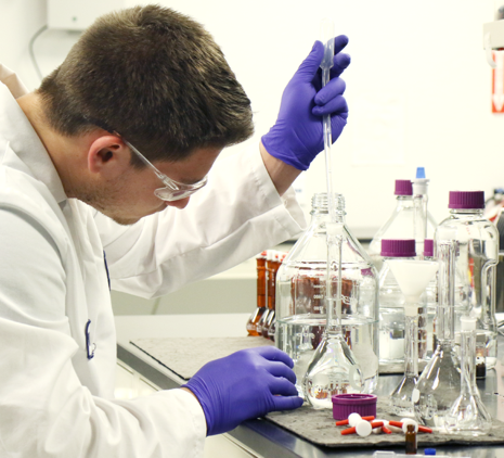 A photo of a scientist performing a lab experiment.