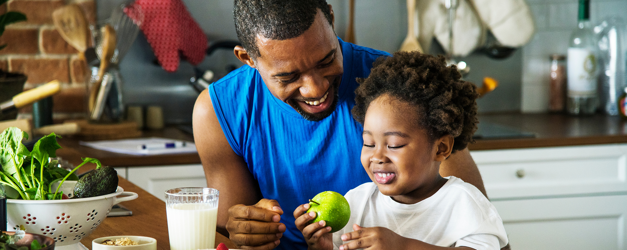 Father introducing an apple to a child.