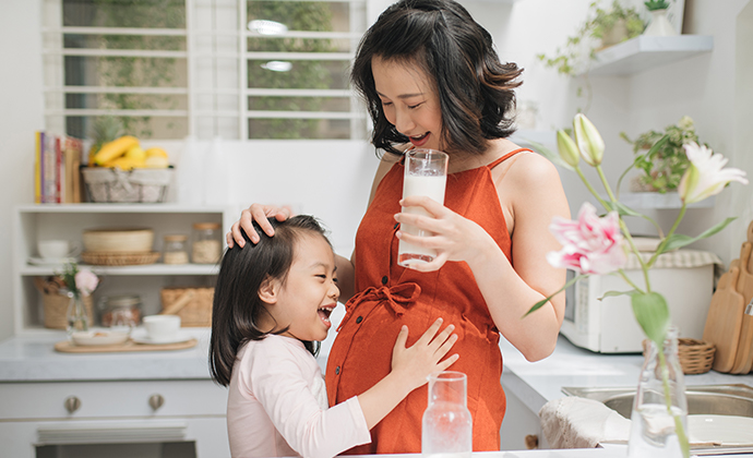 mom holding a glass of milk