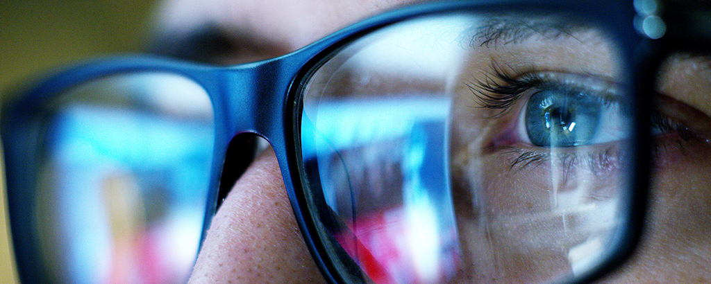 A picture of a blue light exposure on a man wearing glasses.