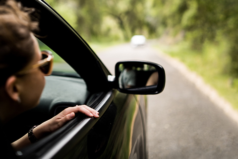 person looking out the window of a car