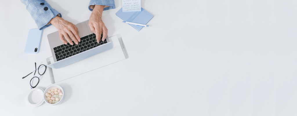 A person using a computer at their desk.