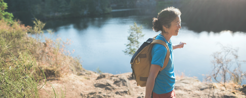 woman hiking near a lake