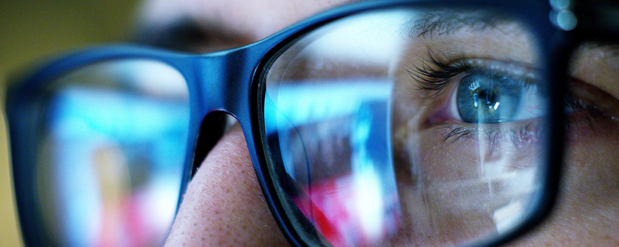 A picture of a blue light exposure on a man wearing glasses.