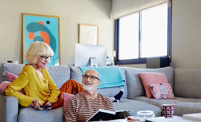 An image of two parents sitting in their living room.