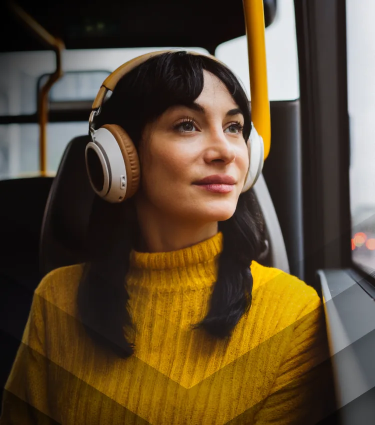 Lady on a bus with headphones on