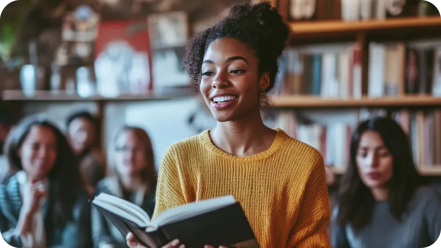 Women reading a book to a group of people