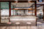 V-Ray render showing cafe area with bar stools under spotlights with kitchen area in the background.