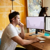 A man working on a computer at his desk.