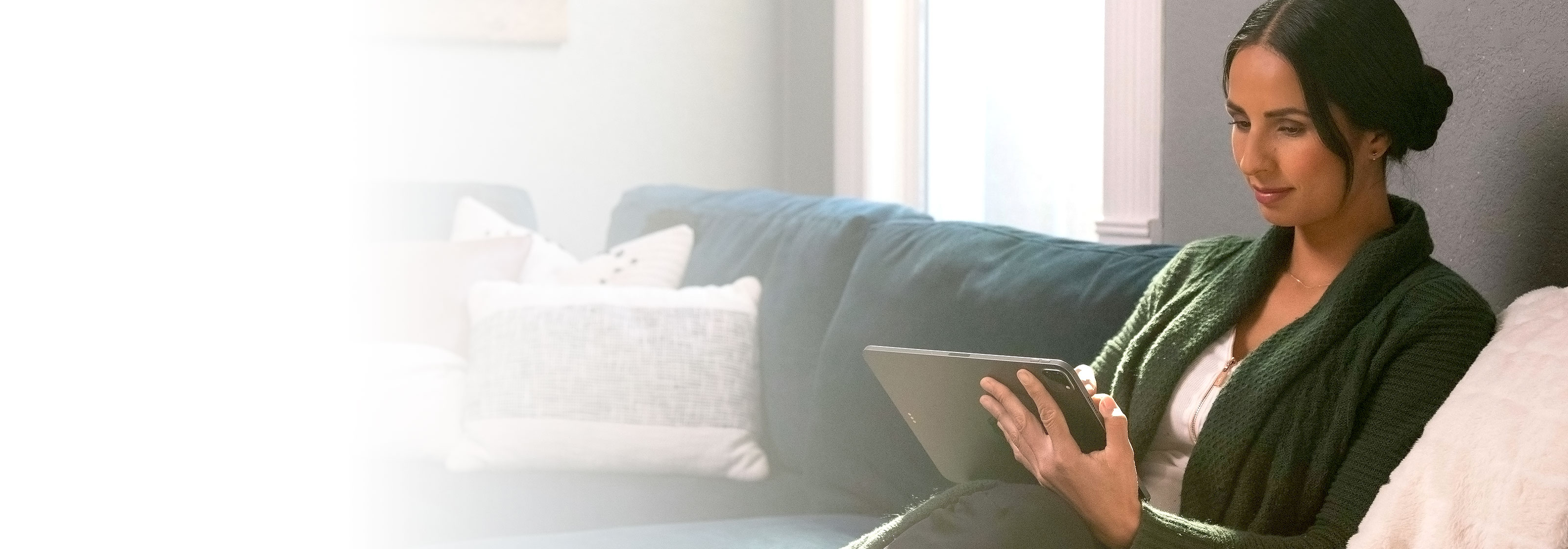 Woman sitting on a couch working with SketchUp for iPad.