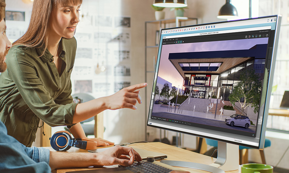 Zwei Menschen begutachten auf einem großen Computermonitor ein Architektur-Rendering in Trimble SketchUp.