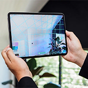 Hands holding an iPad showing SketchUp Scan-to-Design