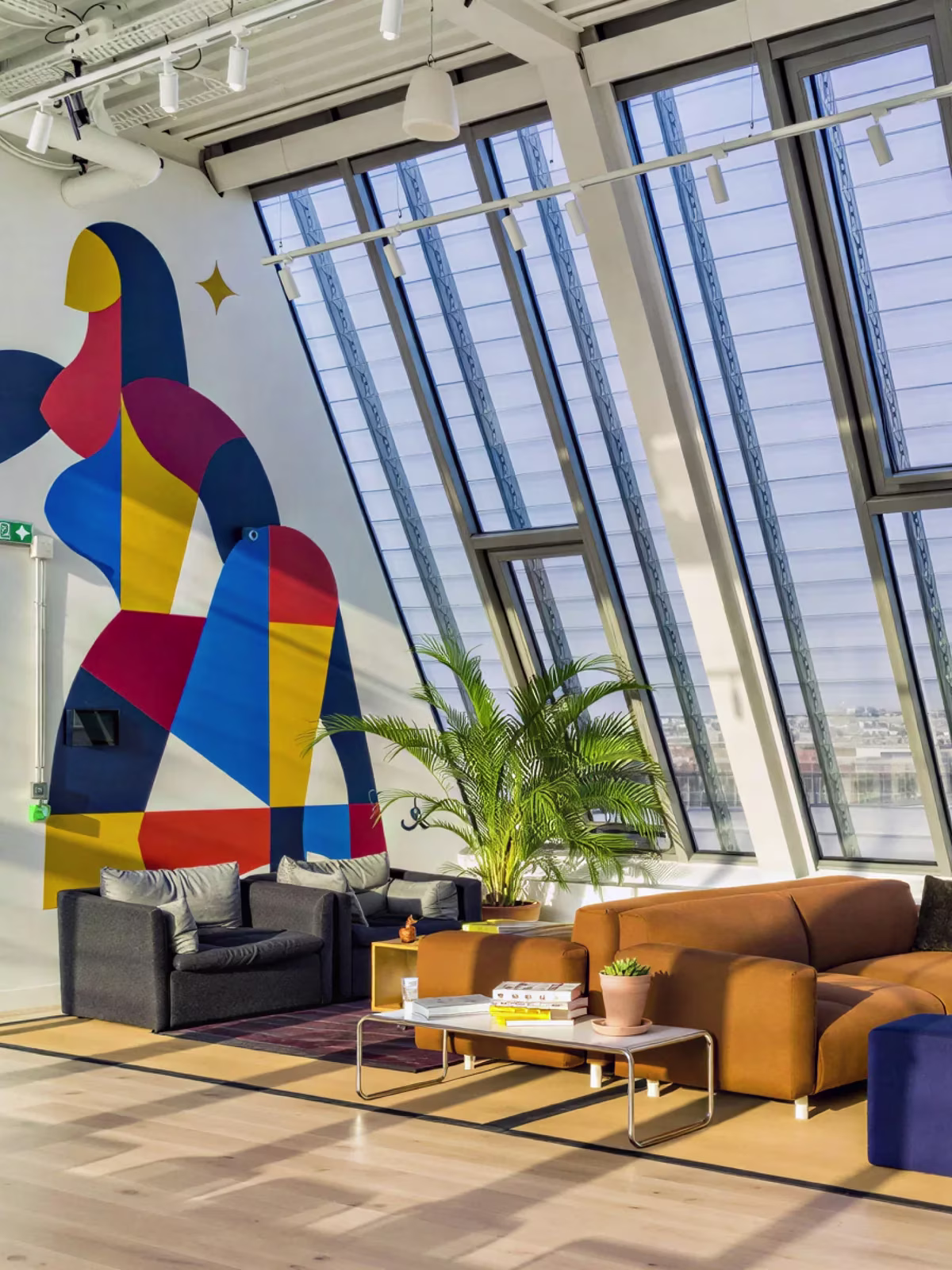 The Paris office, with a colourful mural under sloped studio windows