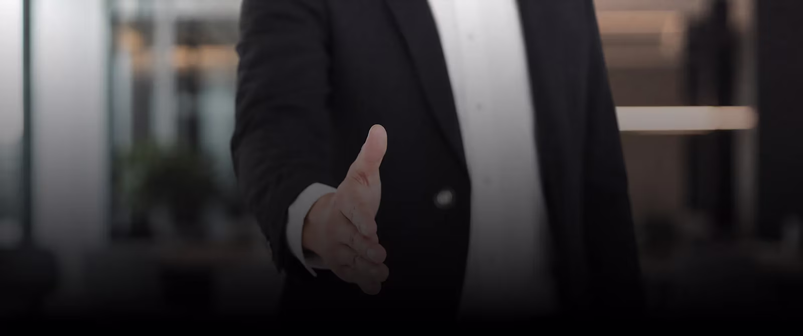 A founder extending a hand for a handshake