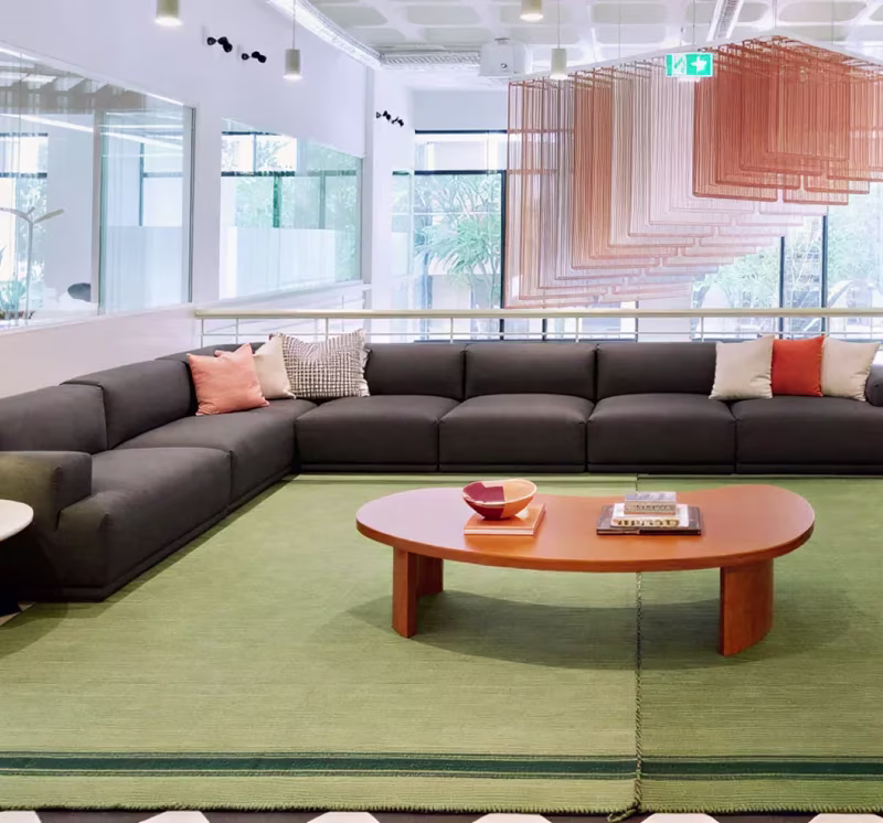 The Lisbon office lounge, with a long sofa around a low round table