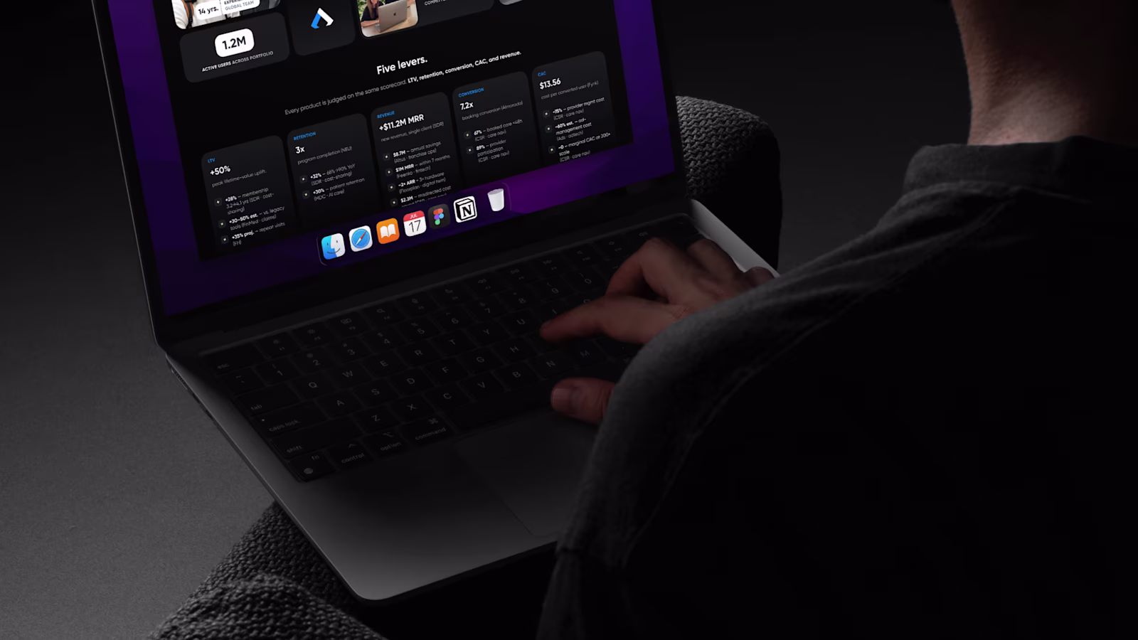 A Reliqio engineer at work on a laptop, the screen the only light in a dark room