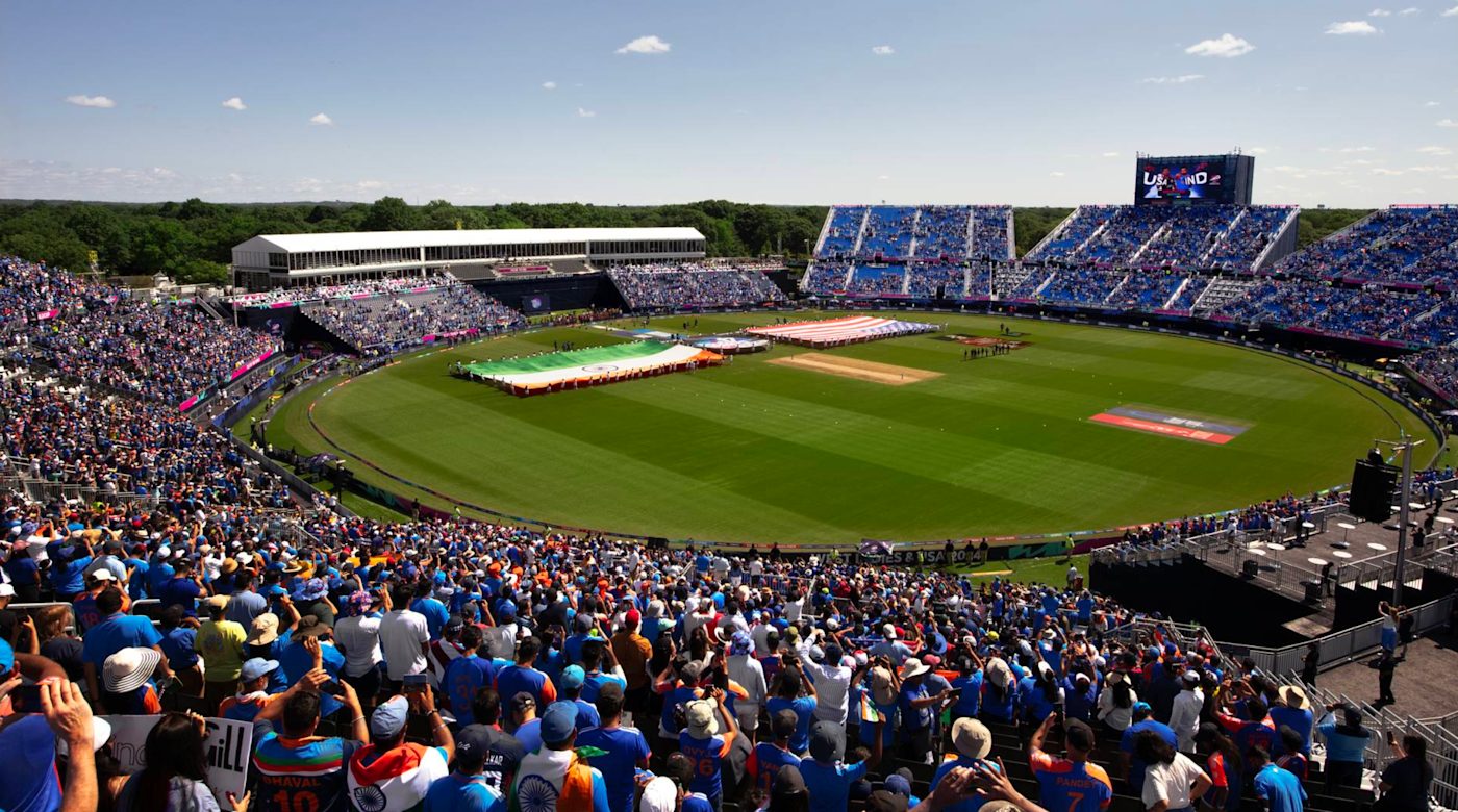 Nassau County International Cricket Stadium during the 2024 T20 World Cup, packed with fans, dusk lighting on the modular stands