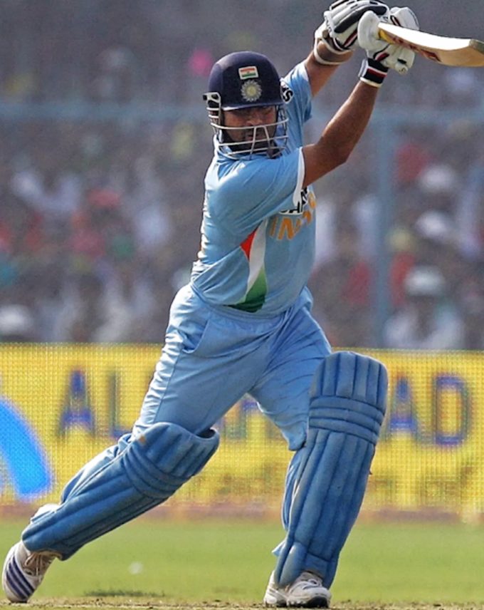 Side-on view of a cover drive showing the triangular shape formed by the bat, arms and torso