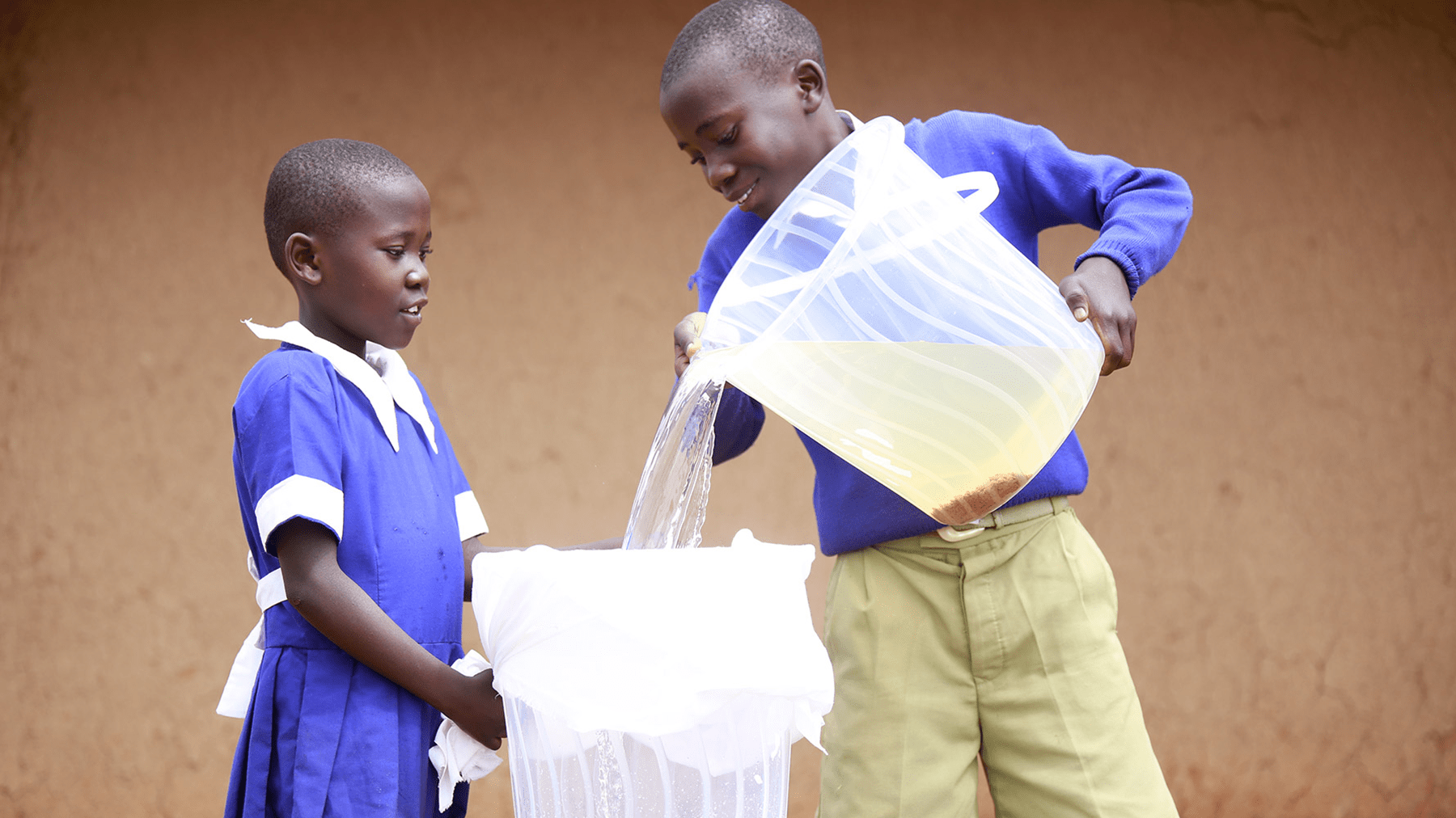 P&G and CSDW Africa student along with classmate demonstrate water purification process