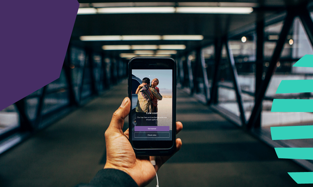 a hand holding a phone with worldremit app at the airport“A